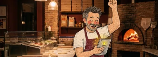 Toni, muy contento, levanta el puño mientras mira en una tablet el pedido nuevo que acaba de llegar a su cocina